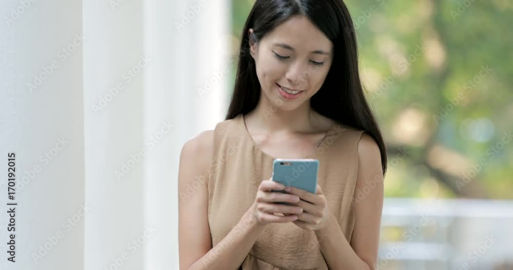 Woman sending sms on cellphone and walking in the campus Woman sending sms on cellphone and walking in the campus