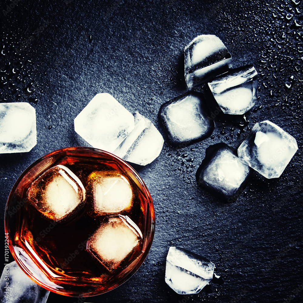 Cold whiskey with ice, black background, low key, top view Stock Photo |  Adobe Stock