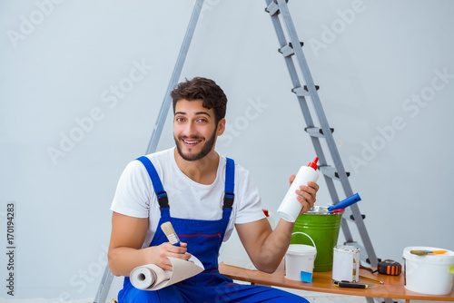 Repairman doing renovation repair in the house with paper wallpa