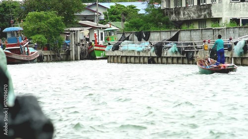 Fishing boat entering harbor photo