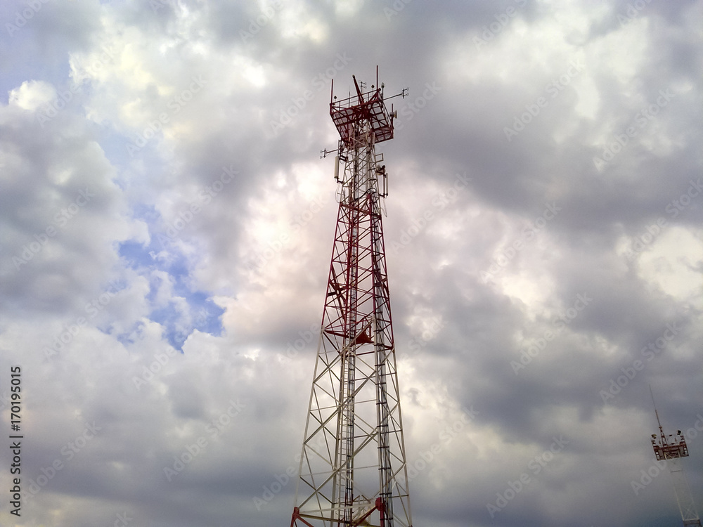 Cellular tower. Telecommunication tower. Communication tower against the sky with clouds.