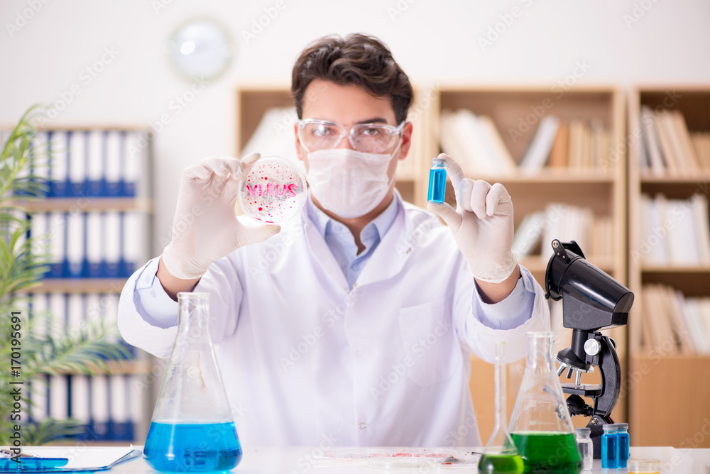Male doctor working in the lab on virus vaccine Male doctor working in the lab on virus vaccine