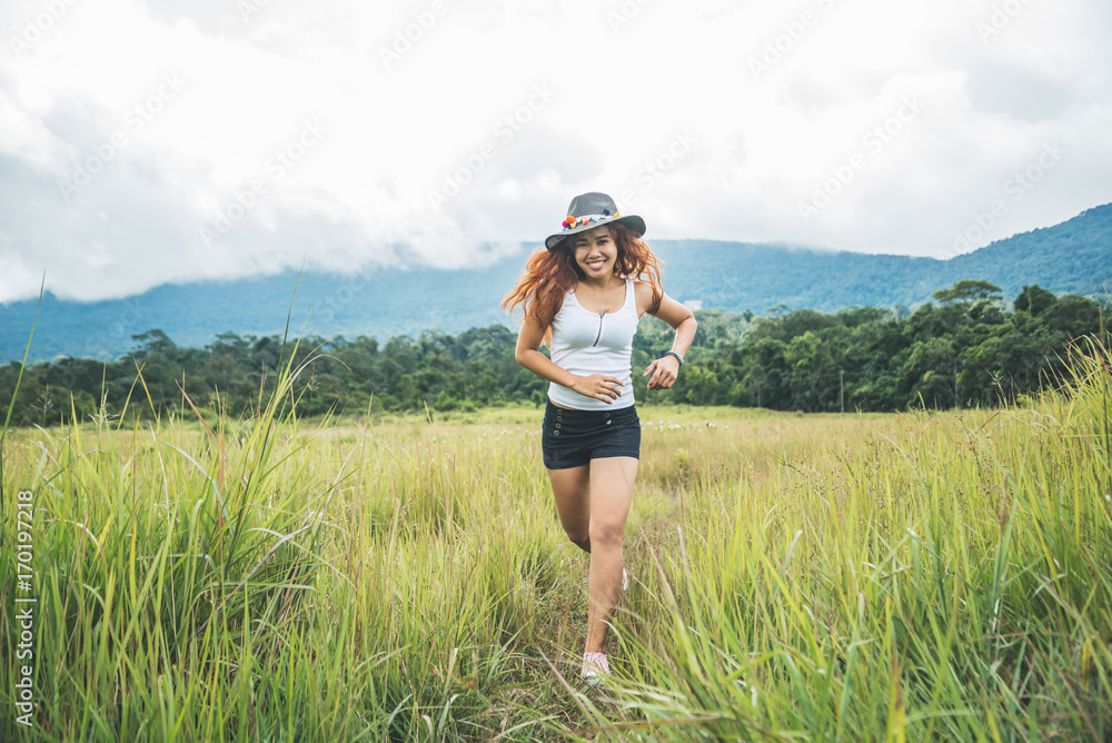 Asian women travel relax in the holiday. on a green pasture. Asian women travel relax in the holiday. on a green pasture.