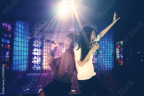 Two women singing in the night club