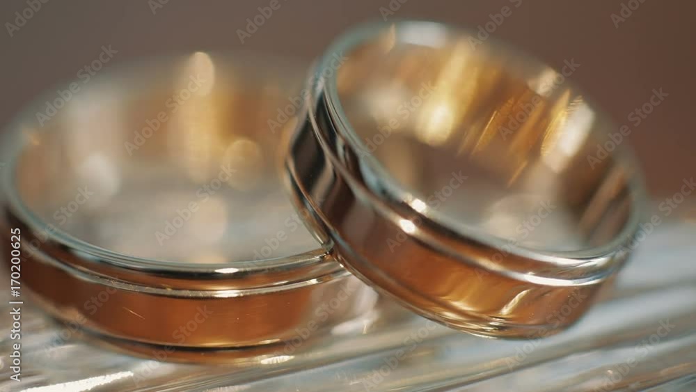 Wedding rings lying on light surface shining with light close up macro Wedding rings lying on light surface shining with light close up macro
