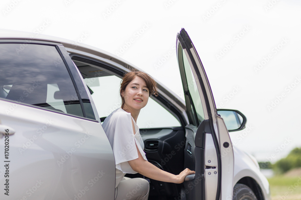 woman getting out of a car.