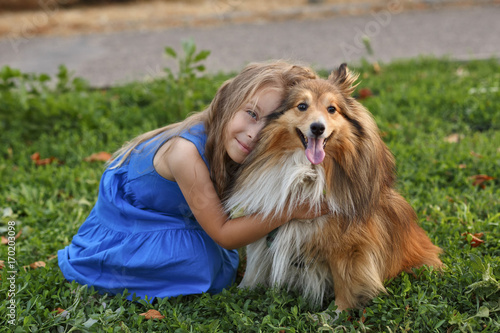 Little girl with a dog Sheltie