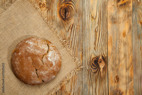 Wheat and traditional Ukrainian bread on a wooden background