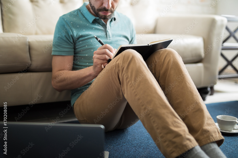 Young man concentrated writing Young man concentrated writing