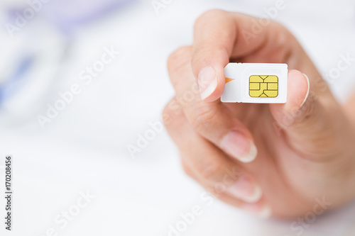 Hand holding sim card, select focus