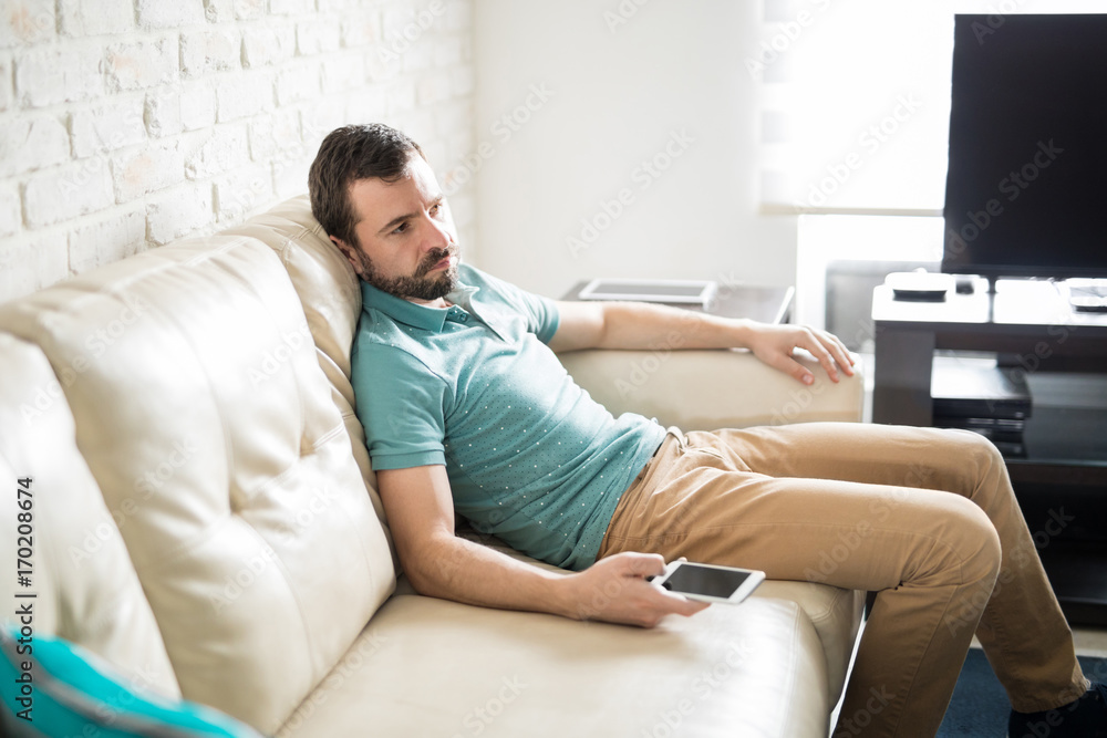 Man sitting and alone looking bored Man sitting and alone looking bored