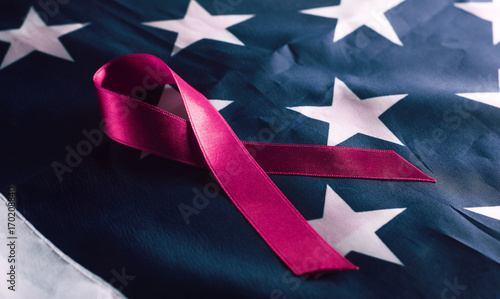 breast cancer, pink ribbon symbol on American flag background