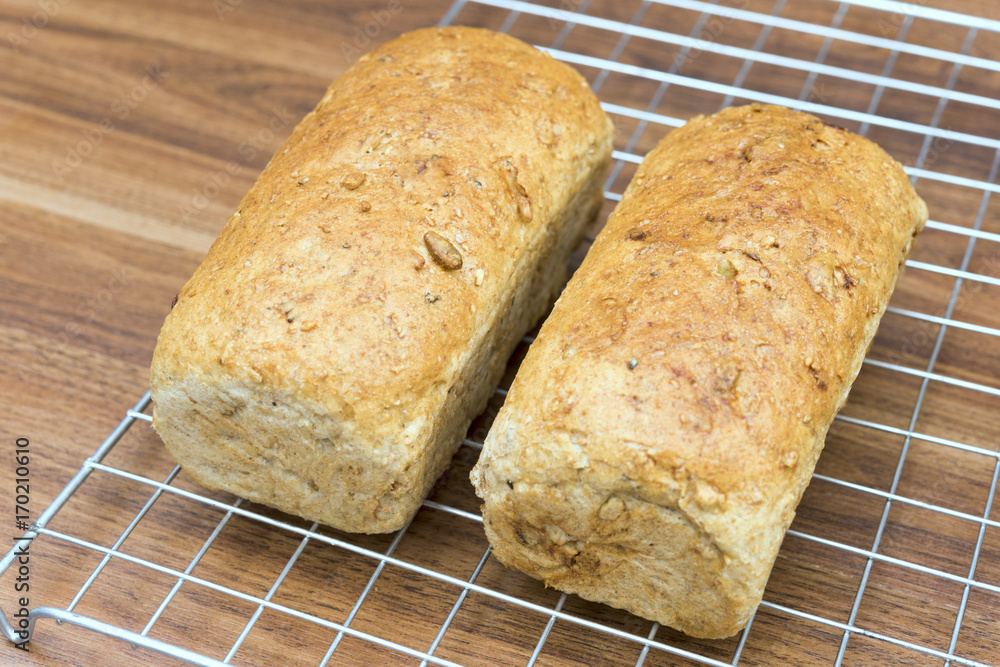 2 homemade multigrain bread loaf on wood table 2 homemade multigrain bread loaf on wood table