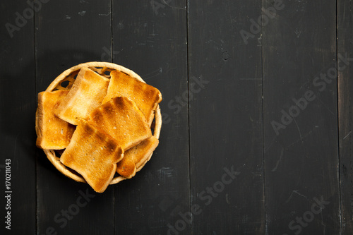 Toasts on a black wooden background photo