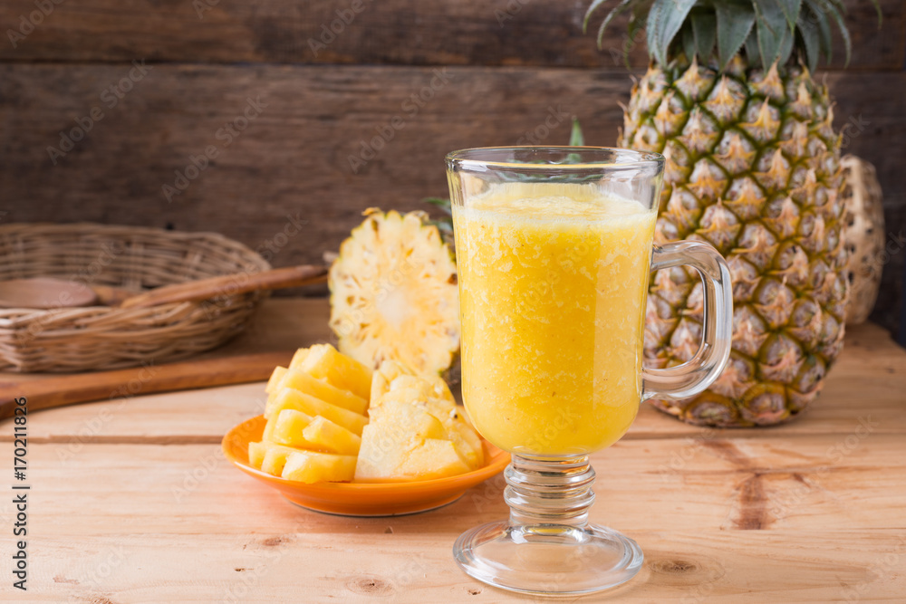Pineapple smoothie on wood background Pineapple smoothie on wood background