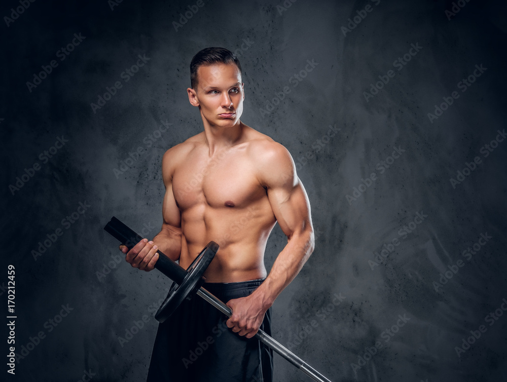 Shirtless male holds barbell.
