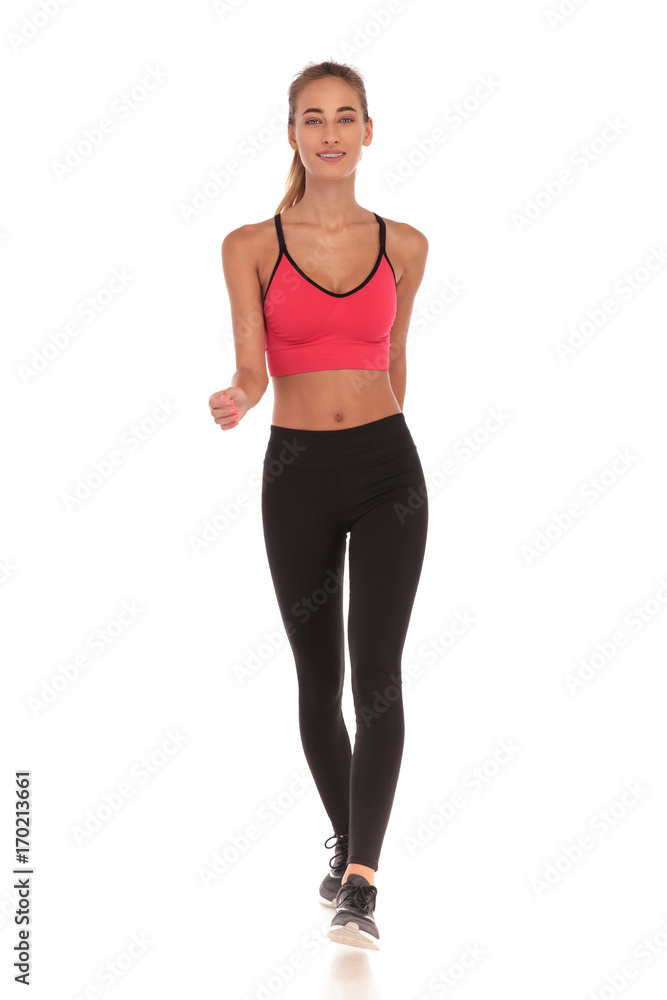 happy fitness young woman walking forward happy fitness young woman walking forward