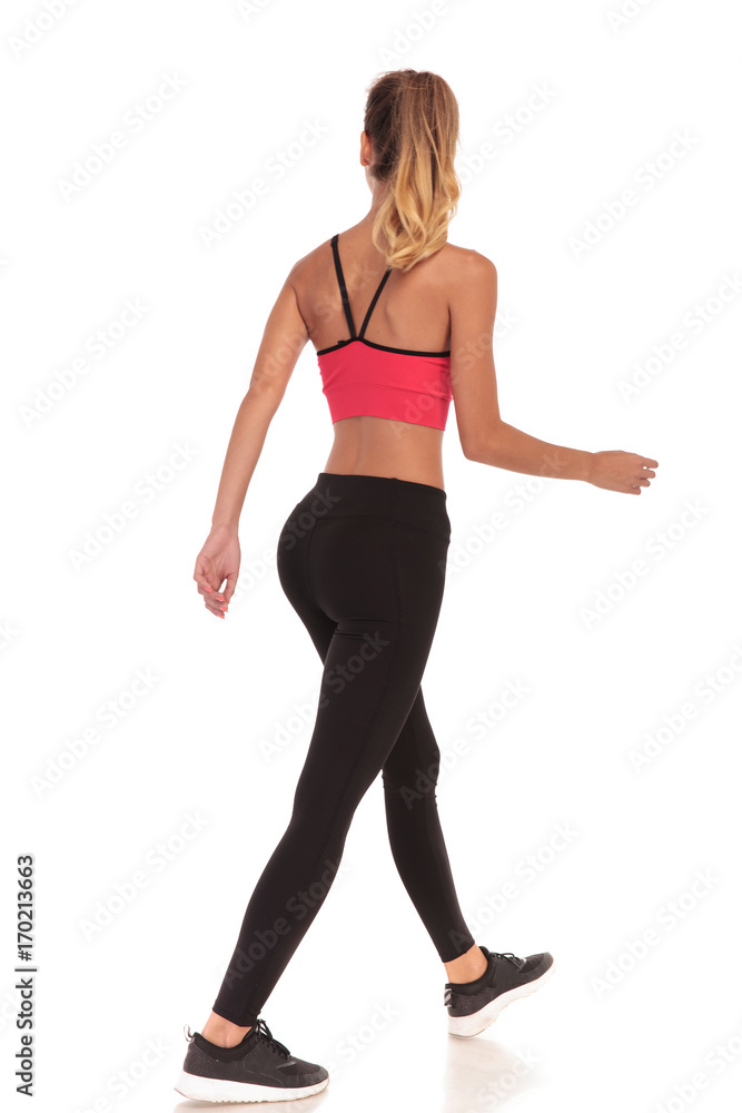 back view of a walking woman fitness instructor back view of a walking woman fitness instructor