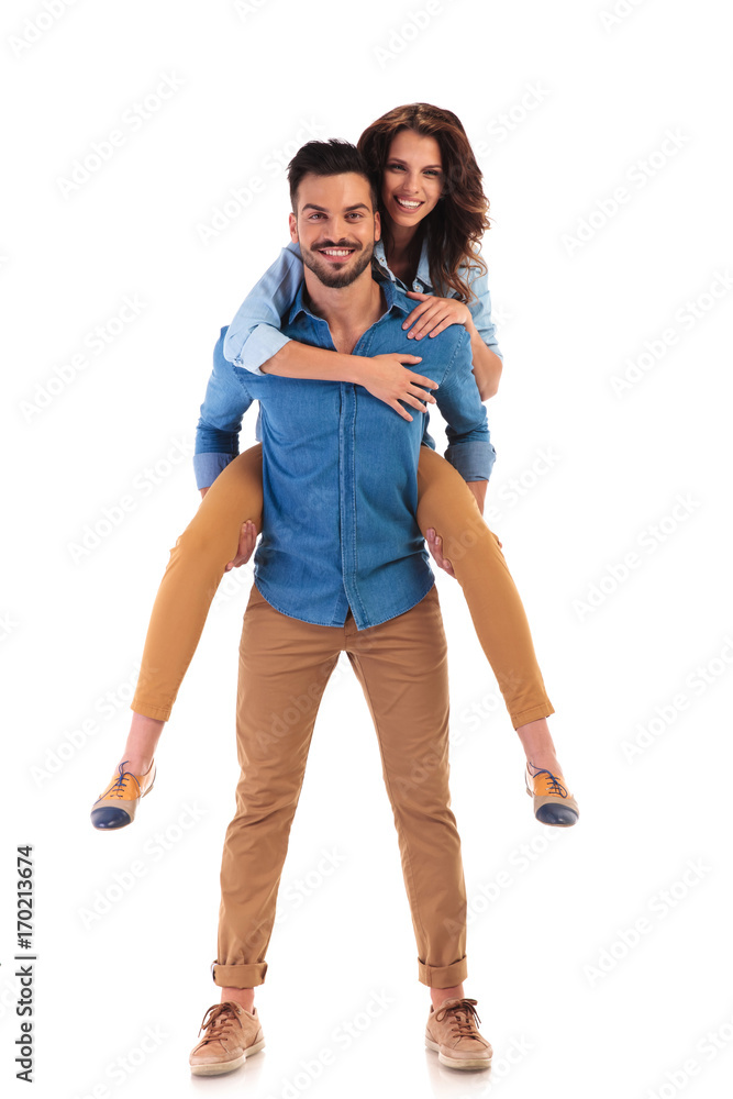 smiling woman on the back of her man smiling woman on the back of her man