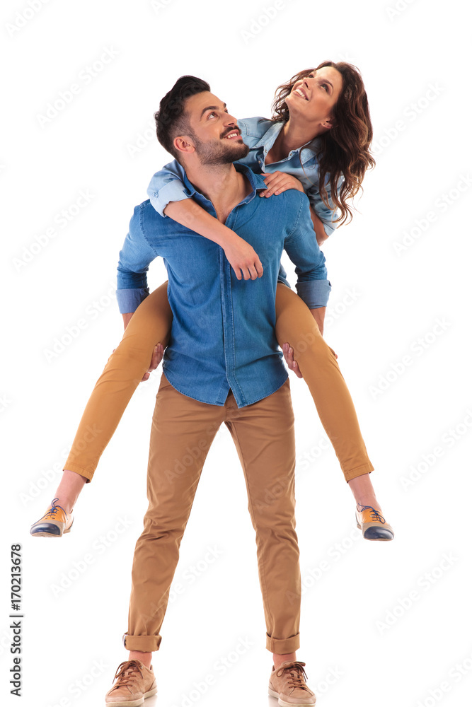 man carrying woman on his back, both looking up man carrying woman on his back, both looking up