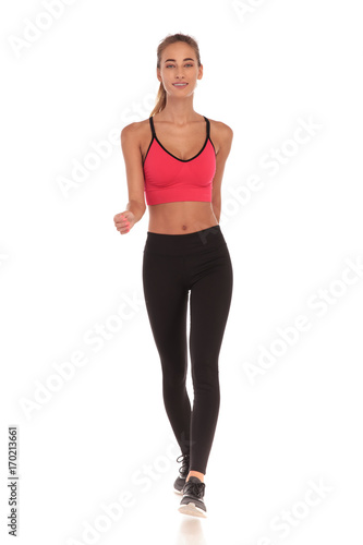 happy fitness young woman walking forward