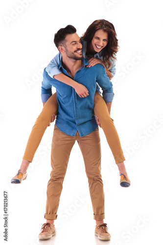 happy man carrying woman on the back photo