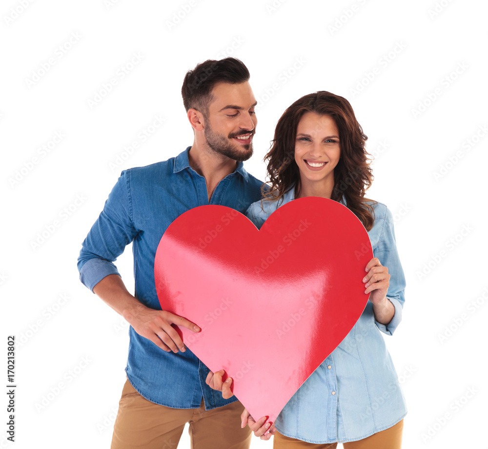 casual couple showing a big red heart