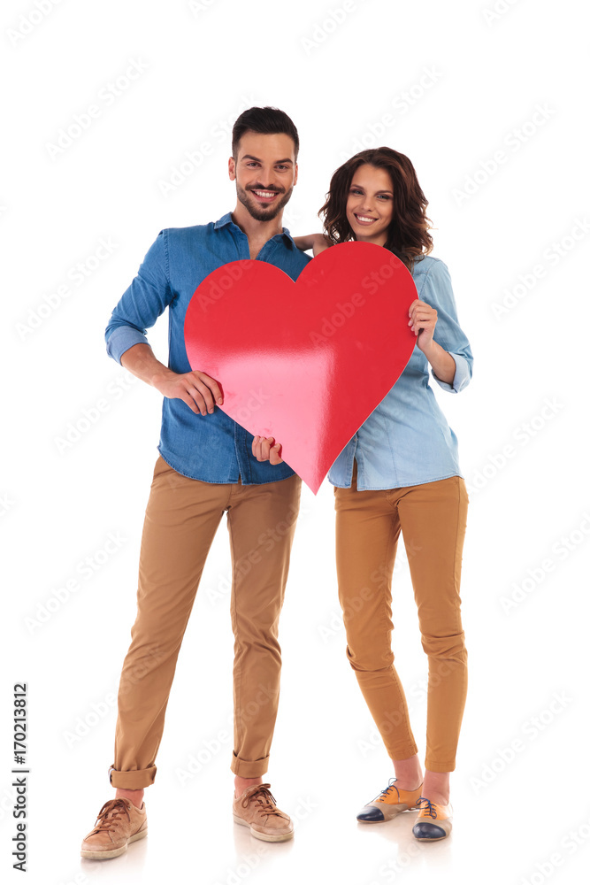 young in love couple holding big red heart young in love couple holding big red heart