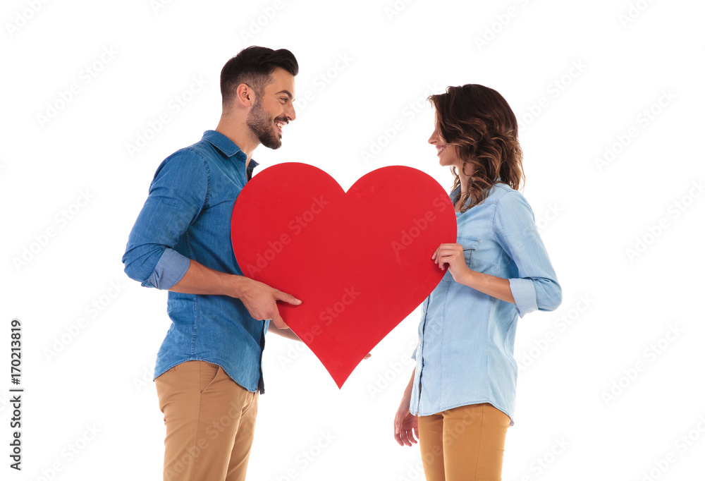 happy in love couple holding big red heart happy in love couple holding big red heart
