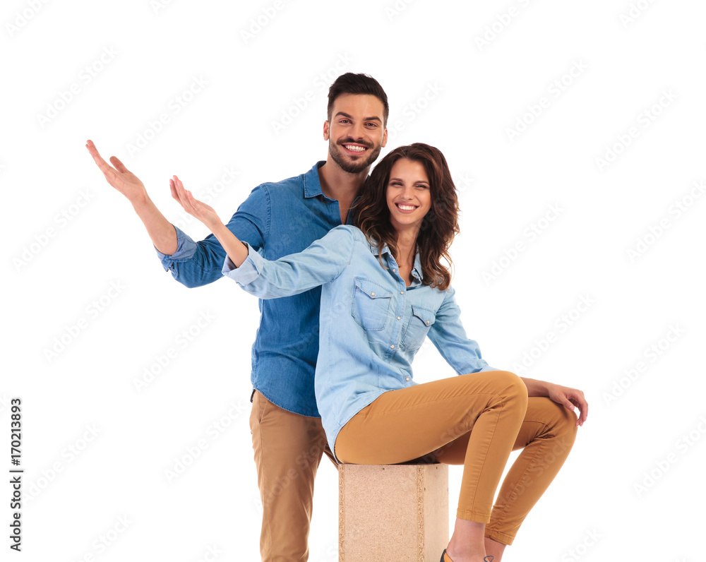 Fototapeta premium happy young casual couple welcoming you