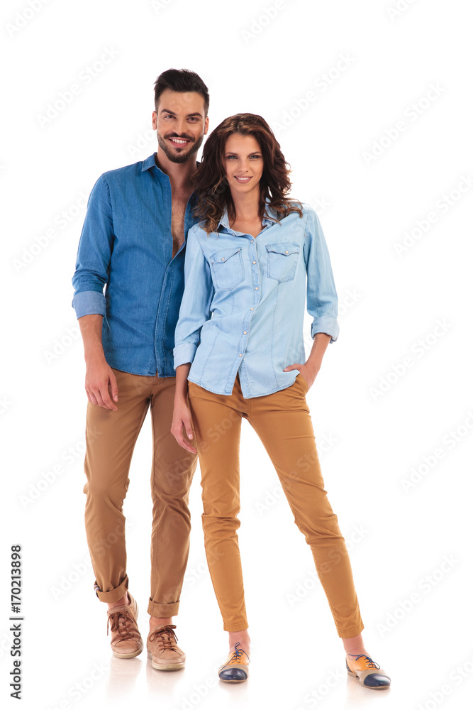 full body picture of young casual couple standing and smiling full body picture of young casual couple standing and smiling