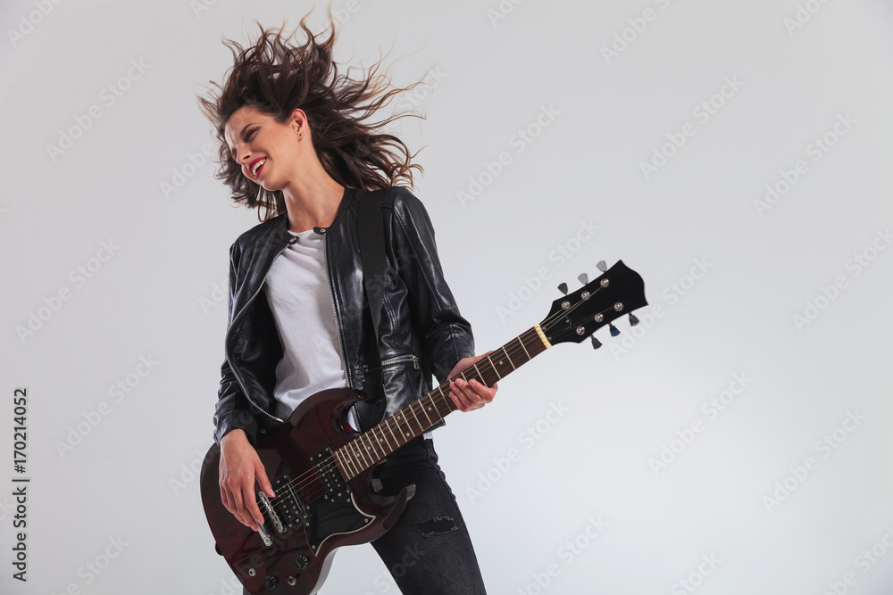happy head banging woman guitarist playing guitar happy head banging woman guitarist playing guitar