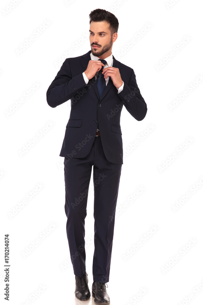 young business man fixing his tie young business man fixing his tie