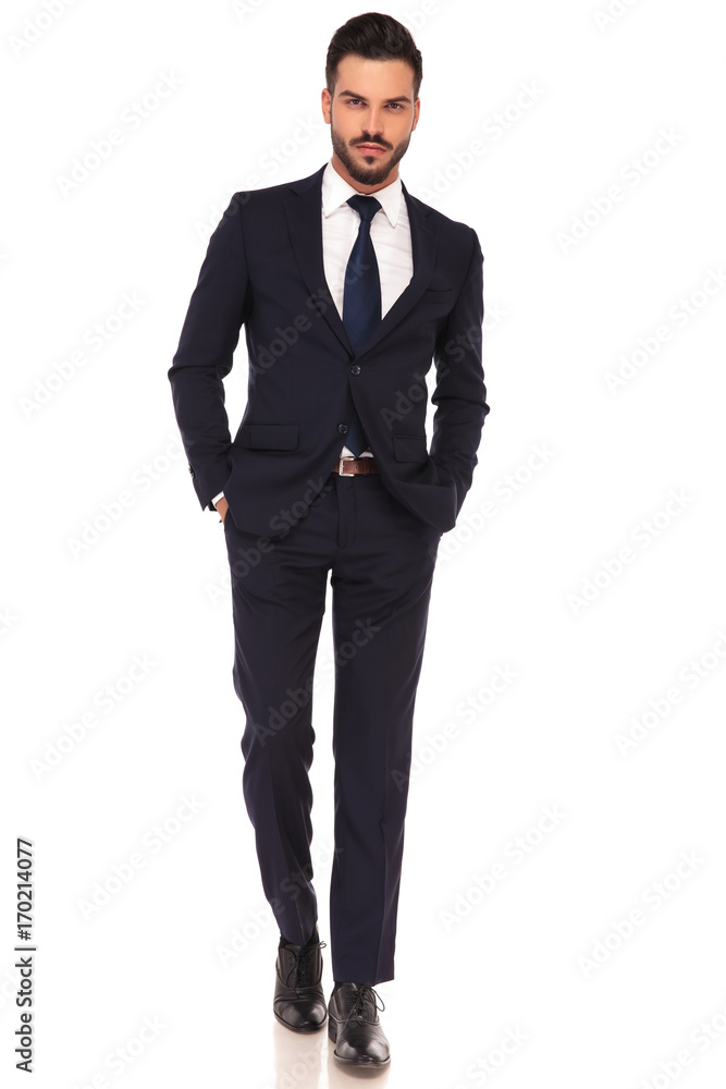 sexy young business man with hands in pockets is walking sexy young business man with hands in pockets is walking
