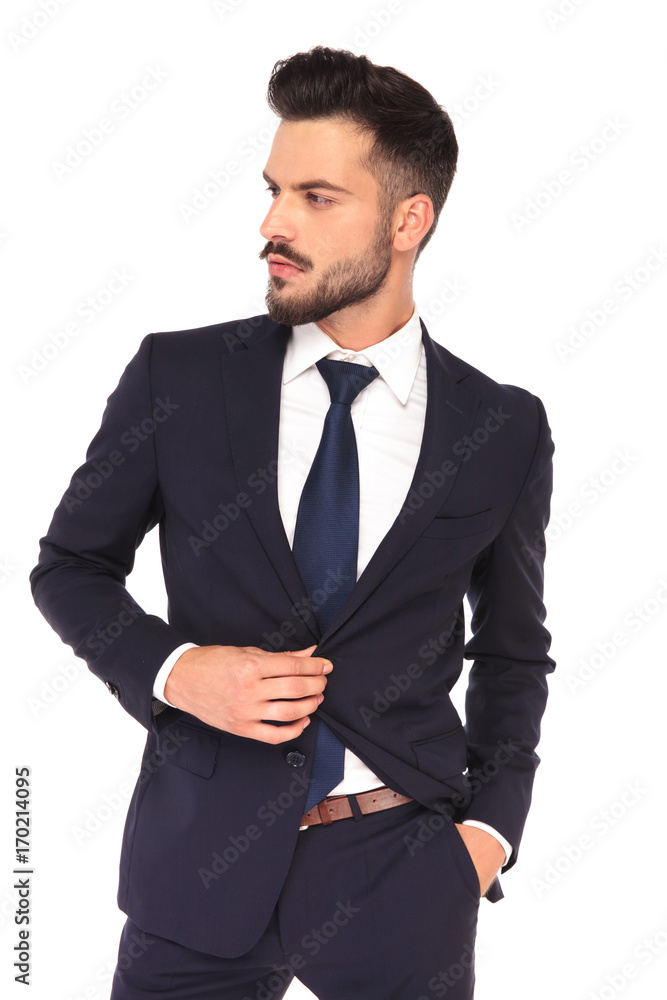 handsome young business man looks to side handsome young business man looks to side