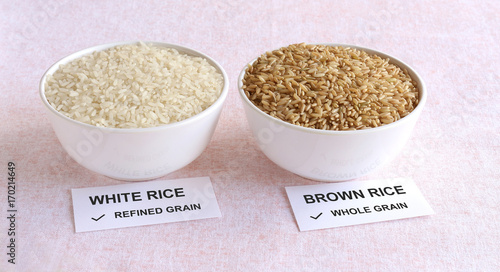 Brown rice, which is a whole grain and healthy food, and white rice, which is a refined grain, in a bowl.