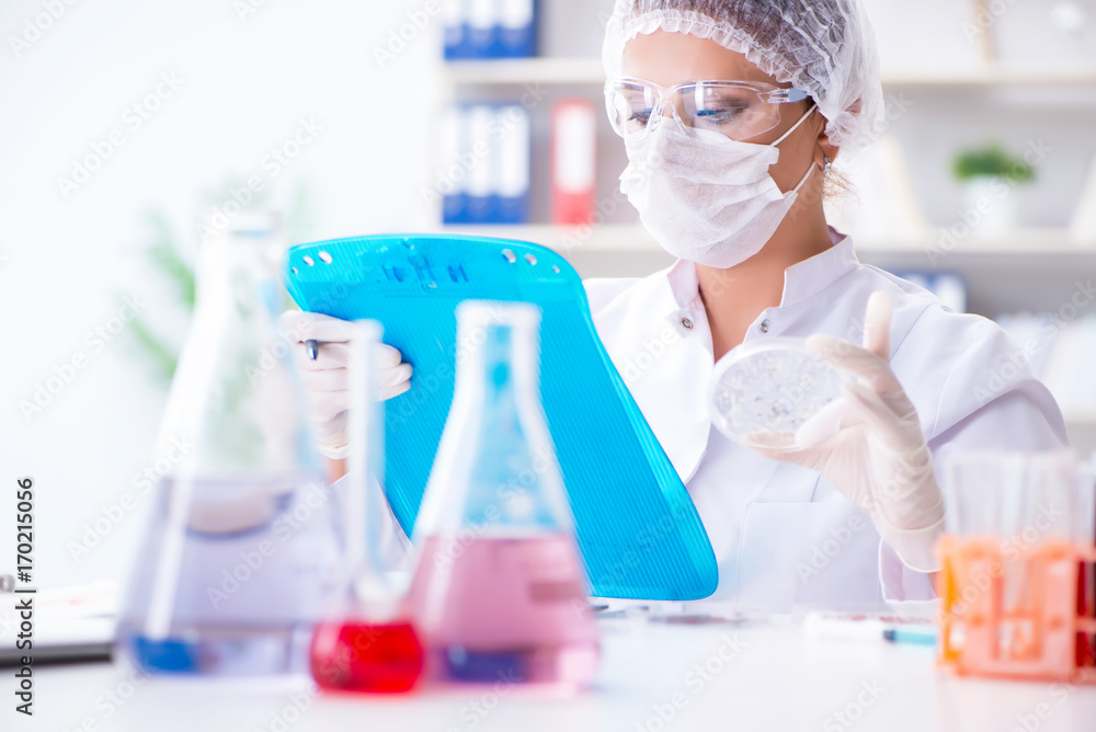 Female scientist researcher conducting an experiment in a labora Female scientist researcher conducting an experiment in a labora