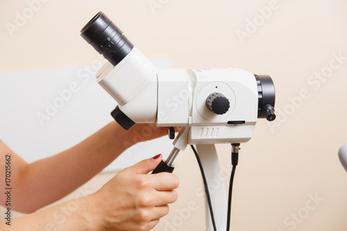 woman gynecologist working with colposcope photo