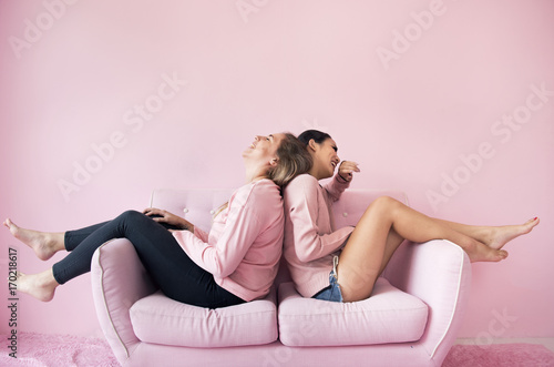 Women friends sitting in living room together