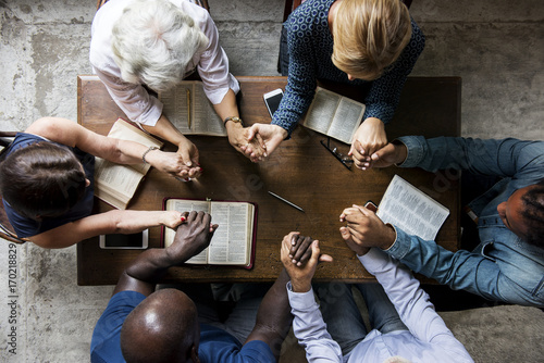 Group of people holding hands praying worship believe