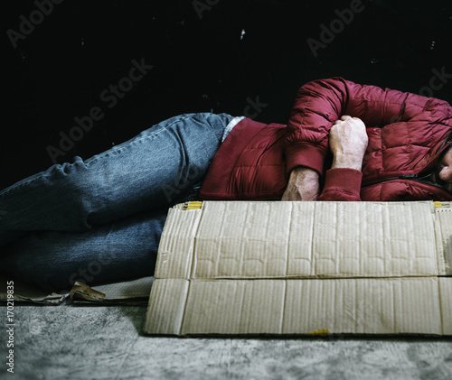 Homeless people lay down on the ground photo