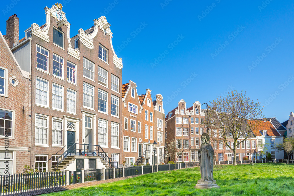 Naklejka premium The historic buildings Begijnhof in Amsterdam city, Netherlands