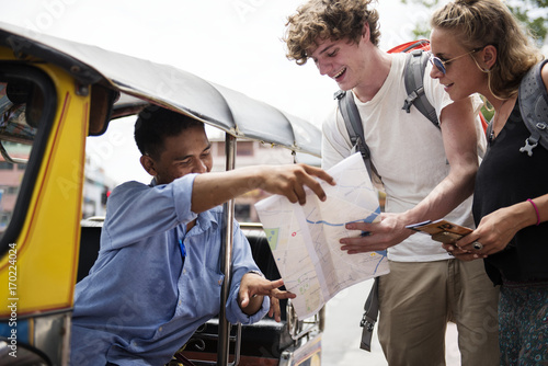 Photography Tourists couple asking tuk tuk native taxi driver for direction