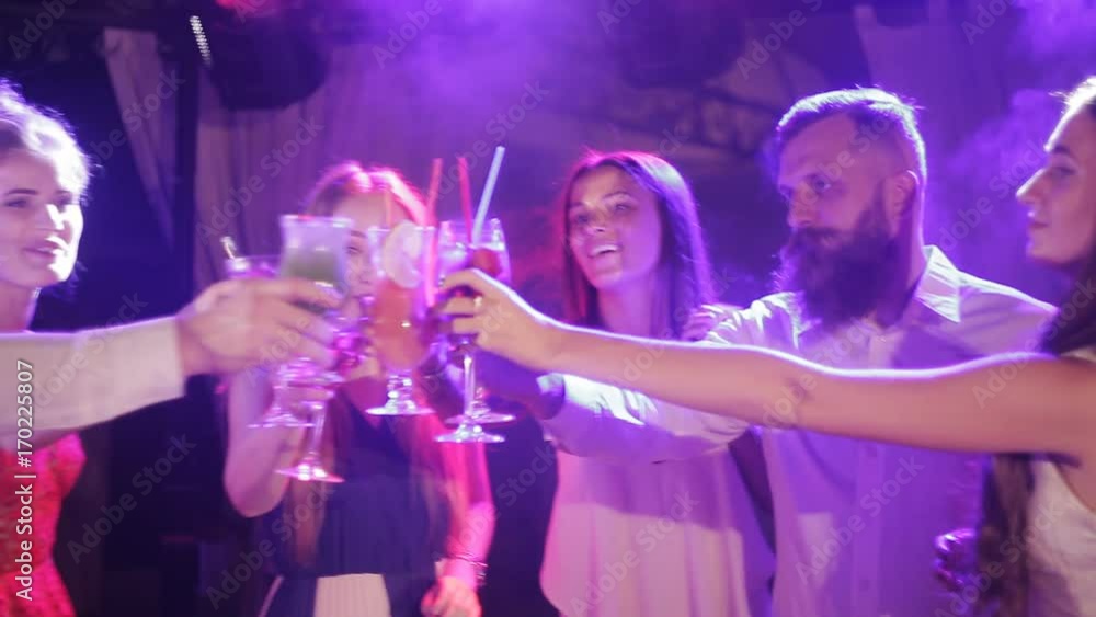 Nightclub : company of friends party and dancing clink glasses. Streamers flying around, Nightclub : company of friends party and dancing clink glasses. Streamers flying around,