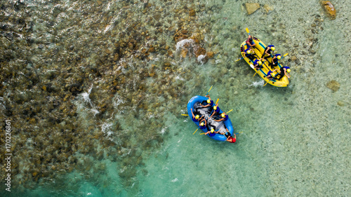 Whitewater Rafting on the Emerald waters of Soca river, Slovenia, are the rafting paradise for adrenaline seekers and also nature lovers, aerial view.