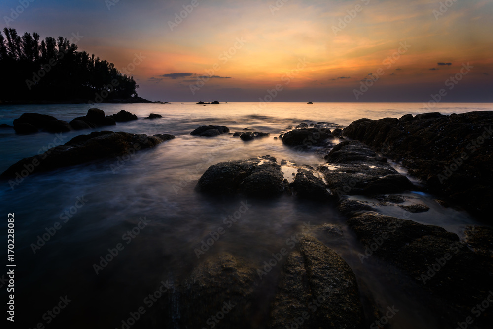 Beautiful Seascape with sea and rock on sunset background.