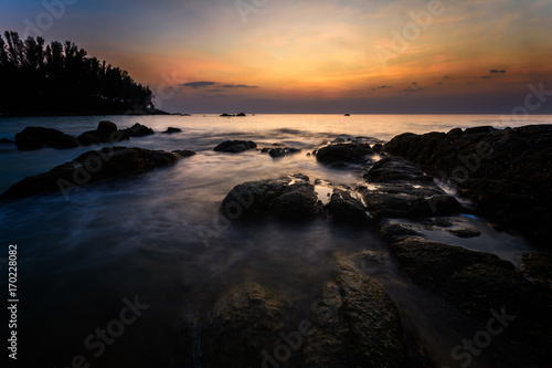 Beautiful Seascape with sea and rock on sunset background.