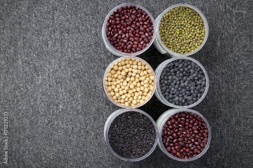 The ranks of different beans: soybean, mung bean, bean, black bean. And black rice. View from above. And copyspace.