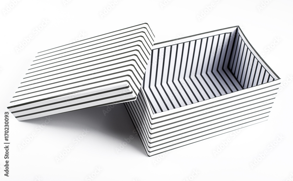 Top view of white box with black stripes open with lid on white background. Isolated. Top view of white box with black stripes open with lid on white background. Isolated.