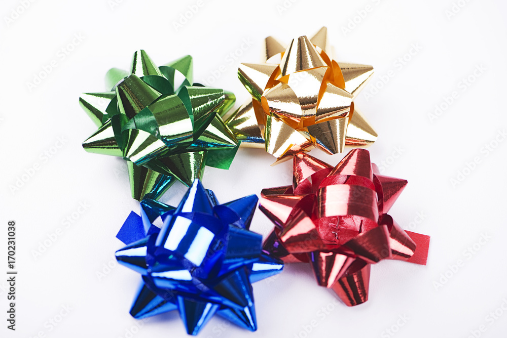 Bow with star shape of green, yellow, blue and red color decoration paper on white background Bow with star shape of green, yellow, blue and red color decoration paper on white background